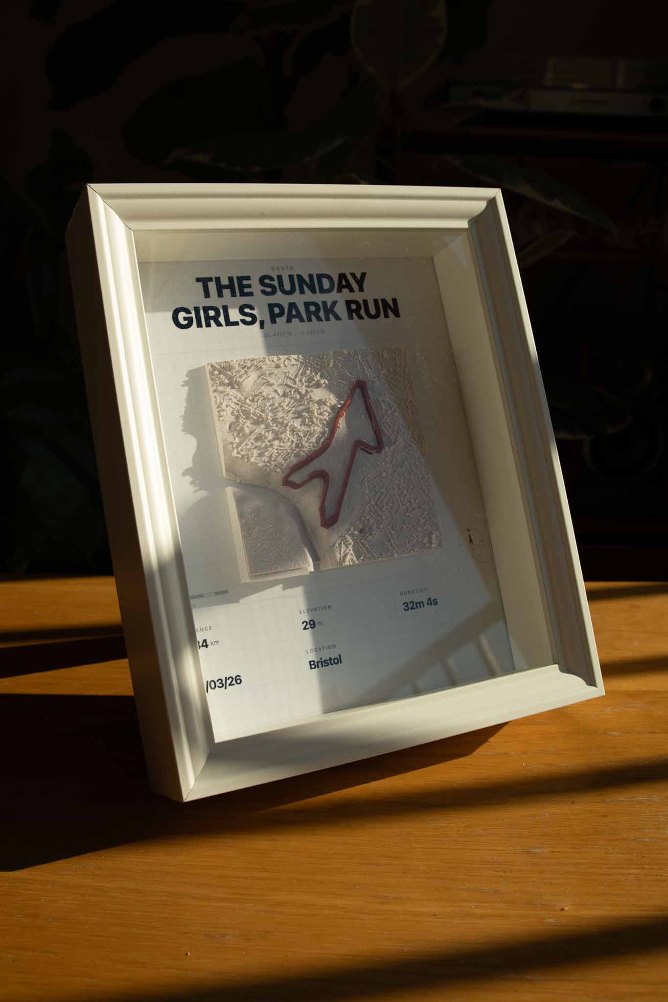 Custom GPX route map mounted in a white wood frame, ready to hang